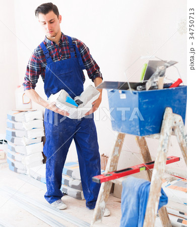 Handyman going kneading putty 34750713
