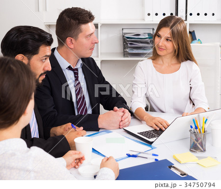 Businesswoman discussing business project with team Businesswoman discussing business project with team 34750794