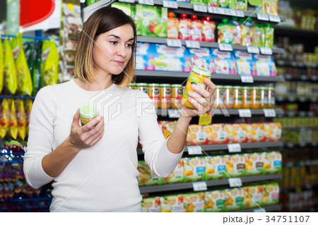 Woman choosing healthy baby food Woman choosing healthy baby food 34751107