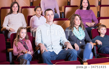 People attentively watching a movie 34751435