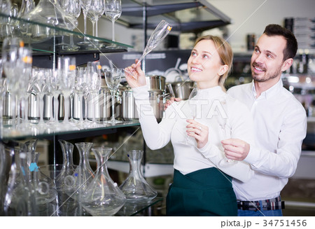 Couple examining crystal glasses 34751456