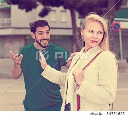 Portrait of female who is angering to adult stranger 34751605