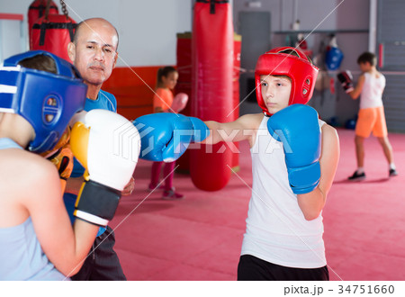 Cheerful teenagers practicing boxing punches 34751660