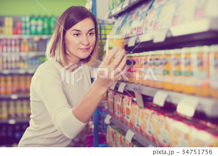 smiling girl customer looking for tasty baby food 34751756