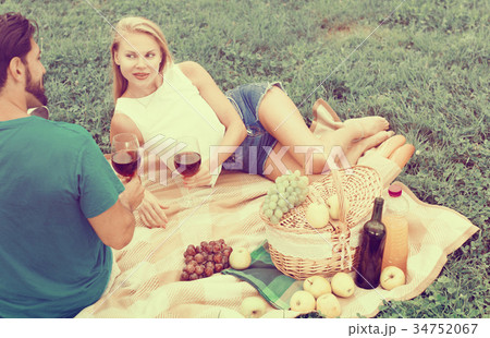 Couple are talking lying and drinking wine Couple are talking lying and drinking wine 34752067