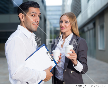 Businesswoman is talking with partner before signing contract 34752069