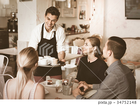 Waiter showing hospitality and serving visitors Waiter showing hospitality and serving visitors 34752148