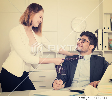 Business couple flirting in office Business couple flirting in office 34752149
