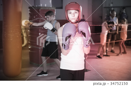 Young serious teenager with boxing gloves 34752150