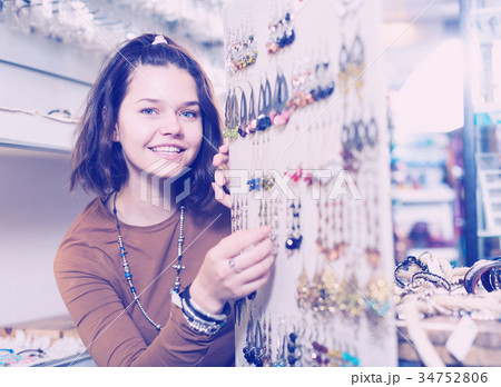 Woman offering to buy fashionable earrings 34752806