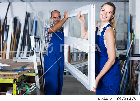 Two professional workers working in assembly shop of plastic windows 34753276