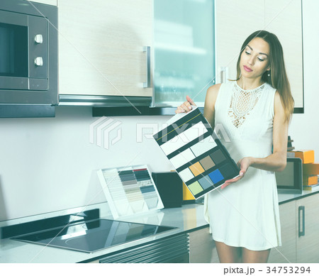 Woman choosing new kitchen tabletop Woman choosing new kitchen tabletop 34753294