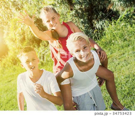 Laughing kids running on grass Laughing kids running on grass 34753423