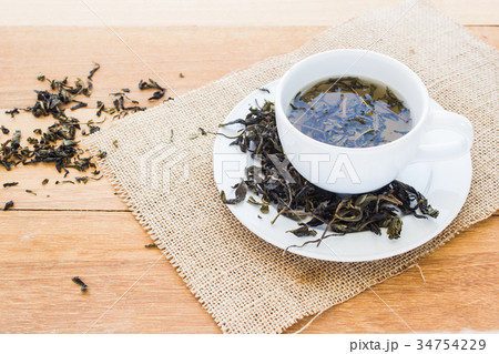 Cup of hot tea on wooden table 34754229