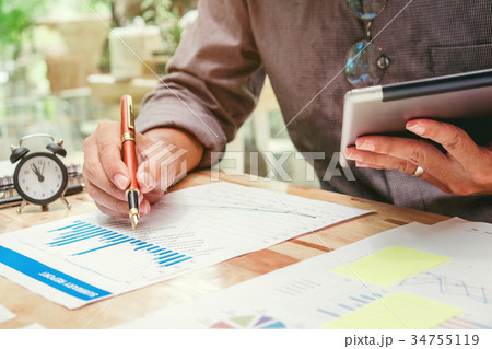 Business man Using digital tablet  Report chart  34755119