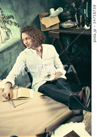 Architect working on drawing table in office 34758739