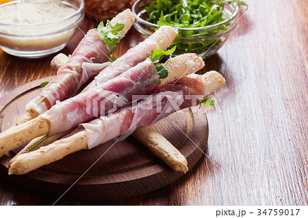 Italian grissini with ham prosciutto, mozzarella 34759017