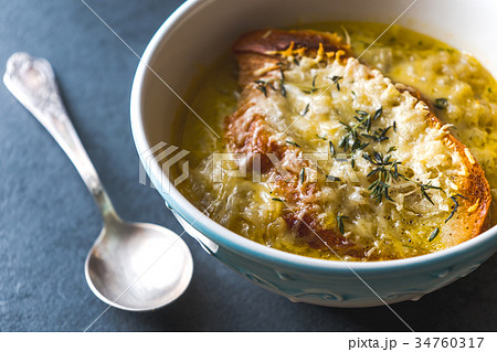 French onion soup with cheese and croutons and a 34760317