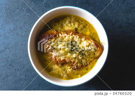 Onion soup with cheese, croutons and thyme in a Onion soup with cheese, croutons and thyme in a 34760320