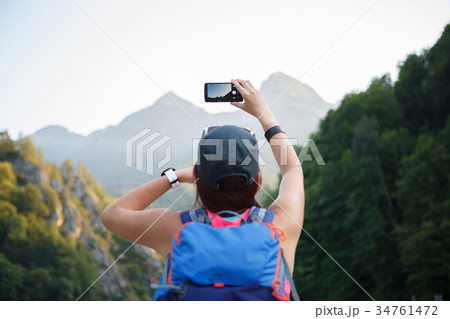 Photo from back of girl with backpack with 34761472