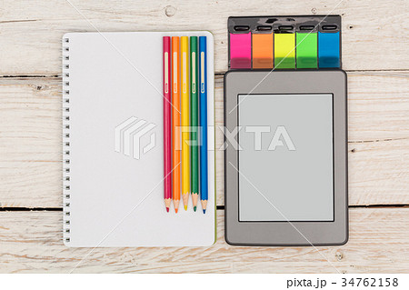 Top view: ebook, notebook and colored pencils Top view: ebook, notebook and colored pencils 34762158