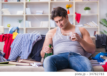 Young man student drunk drinking alcohol in a 34762783