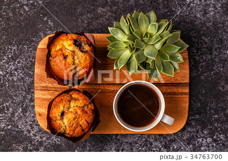 Table with muffins, flower and coffee. Table with muffins, flower and coffee. 34763700