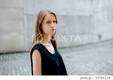 Portrait of young pretty girl with serious face. Portrait of young pretty girl with serious face. 34764129