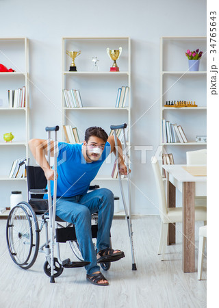 Young man recovering after surgery at home with Young man recovering after surgery at home with 34765643