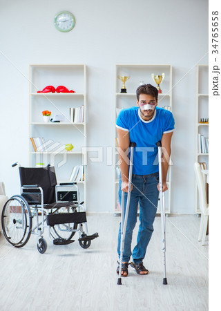 Young man recovering after surgery at home with 34765658