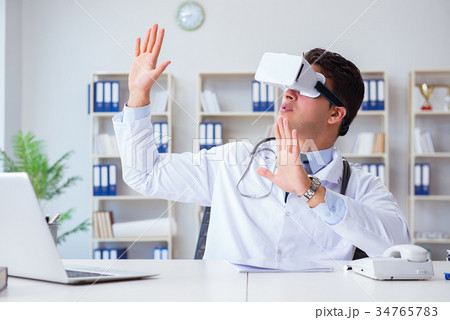 Young doctor with vr virtual reality headset 34765783
