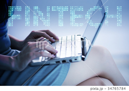 Hands working on laptop in financial technology 34765784