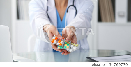 Female doctor hand holding pack of different Female doctor hand holding pack of different 34769770