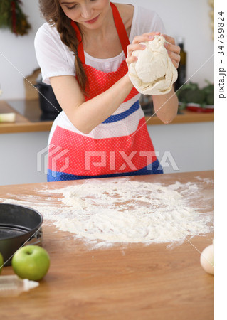 Female hands making dough for pizza or bread on Female hands making dough for pizza or bread on 34769824