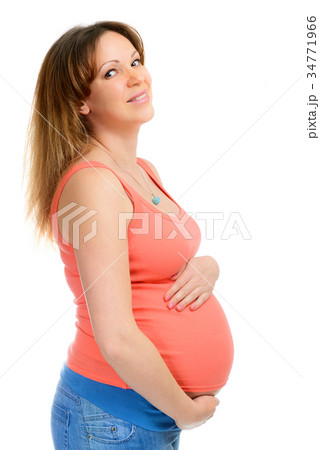 A smiling pregnant woman in jeans 34771966