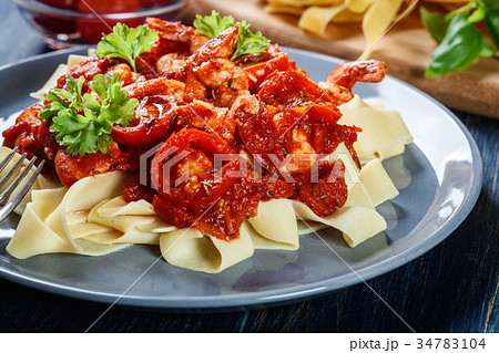 Pappardelle pasta with shrimp, tomatoes and herbs 34783104
