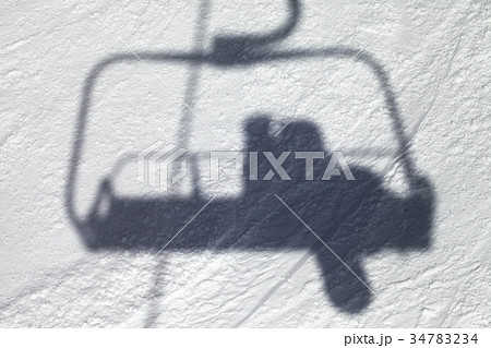 Shadows from chair lift with snowboarder 34783234