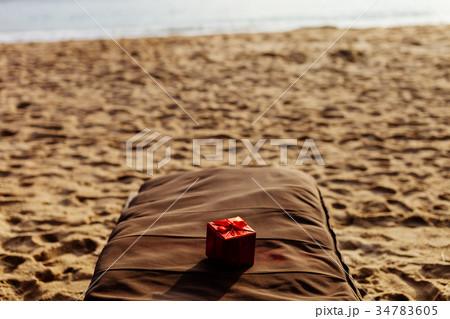 gift in red box on the beach resort 34783605