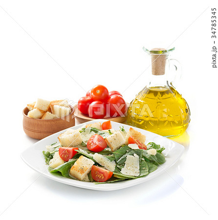 caesar salad in plate on white background 34785345