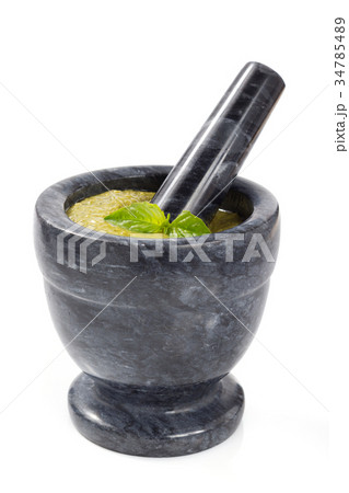 pesto sauce in mortar on white 34785489
