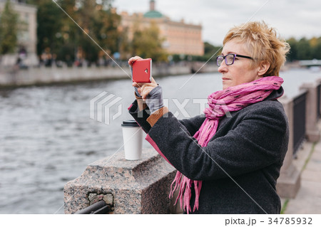 Woman taking shots on waterfront Woman taking shots on waterfront 34785932