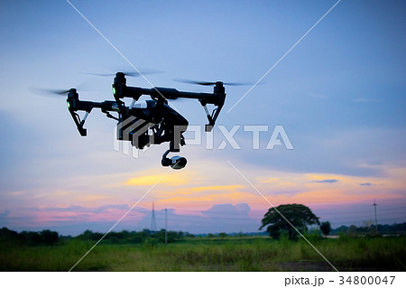 Professional camera drone flying in nature Professional camera drone flying in nature 34800047