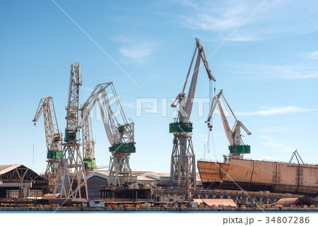 Industrial cargo cranes in the dock 34807286