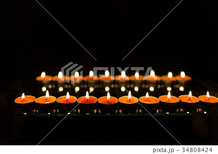 Many burning candles with shallow depth of field 34808424