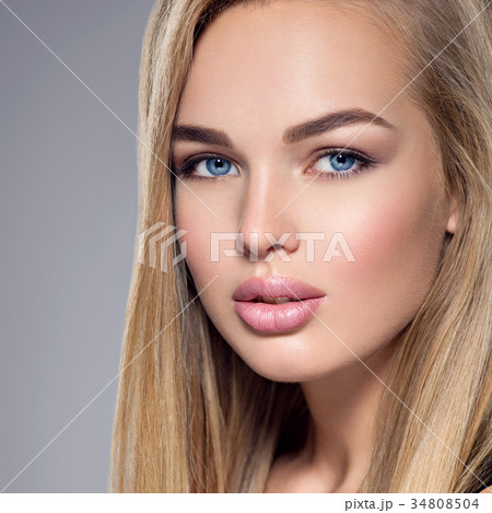 Beautiful young woman with blue eyes 34808504