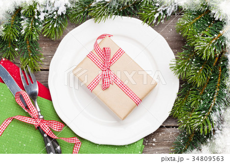 Christmas gift box over plate, silverware, firtree Christmas gift box over plate, silverware, firtree 34809563