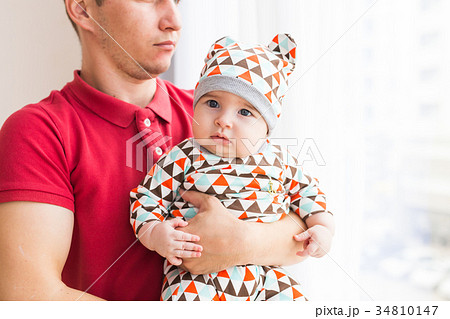Father holding and playing his little baby child 34810147