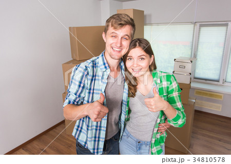 Happy funny couple showing keys of new home Happy funny couple showing keys of new home 34810578
