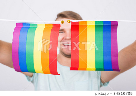 Young man hold a rainbow flag, gey boy. Concept of Young man hold a rainbow flag, gey boy. Concept of 34810709