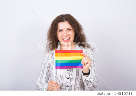 Young lesbian woman holding flags of the LGBT 34810711